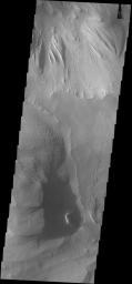 Shadows cast by the high walls and high hills within Candor Chasma are visible in this image from NASA's 2001 Mars Odyssey spacecraft. The local time is near 5:00 in the afternoon.