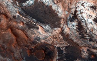 This observation from NASA's Mars Reconnaissance Orbiter shows a small portion of Mawrth Vallis, one of the many outflow channels feeding north into the Chryse Basin. This ancient valley once hosted flowing water.