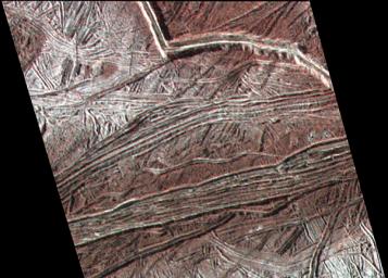 This enhanced color image shows cracks and ridges on Europa's surface that reveal a detailed geologic history. The view was captured by NASA's Galileo spacecraft on February 2, 1999.