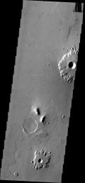 The southern Amazonis Planitia shows two craters with ejecta that stand out above the surrounding surface. The ejecta has remained in place while the surrounding material was removed. This image is from NASA's 2001 Mars Odyssey spacecraft.