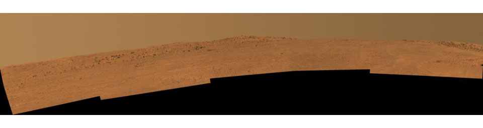 This view toward the south is a mosaic of images taken by Opportunity's Pancam on Dec. 25, 2013. The rover team plans to use Opportunity during 2014 to investigate rock layers exposed on the slope upward toward the McClure-Beverlin Escarpment.