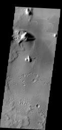 Bright windstreaks are located around several small craters at the top of this image captured by NASA's 2001 Mars Odyssey spacecraft.