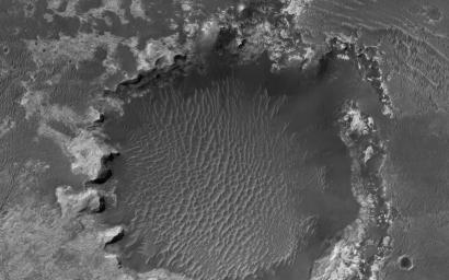 NASA's Mars Reconnaissance Orbiter spies an impact crater located in northern Sinus Meridiani has formed along the boundary of two different terrain units.