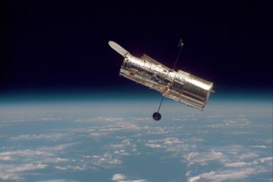 The Hubble Space Telescope hovers at the boundary of Earth and space in this picture, taken after Hubble's second servicing mission in 1997.