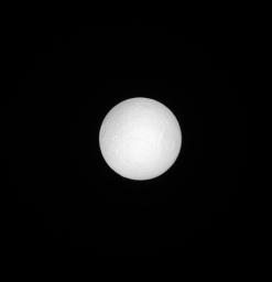 Seen by NASA's Cassini spacecraft, Tethys, like many moons in the solar system, keeps one face pointed towards the planet around which it orbits. Tethys' anti-Saturn face is seen here, fully illuminated, basking in sunlight.
