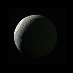 The giant impact basin Odysseus on Saturn's moon Tethys stands out brightly from the rest of the illuminated icy crescent as seen by NASA's Cassini spacecraft.