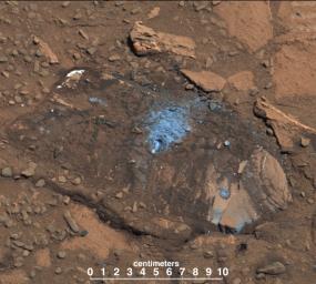 The 'Bonanza King' rock on Mars, pictured here, was tapped by the drill belonging to NASA's Mars rover Curiosity. The tapping resulted in sand piling up on the rock after drilling, showing the rock was not firmly in place.