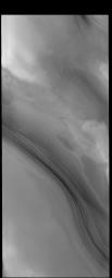 This image captured by NASA's 2001 Mars Odyssey spacecraft shows the layering of the north polar cap. Such layering is visible on the sides of troughs carved into the ice.