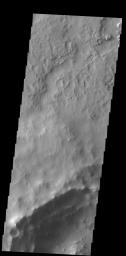 Dark slope streaks mark the rim of this unnamed crater in Terra Sabaea, as shown in this image captured by NASA's 2001 Mars Odyssey spacecraft.