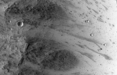 The track left by an oblong boulder as it tumbled down a slope on Mars runs from upper left to right center of this image taken by NASA's Mars Reconnaissance Orbiter.