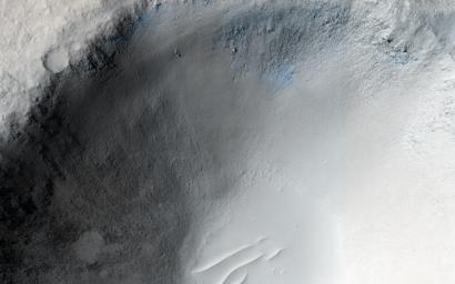 An impact crater in Isidis Planitia observed for a fifth time by NASA's Mars Reconnaissance Orbiter.