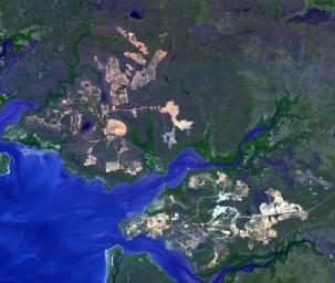 This image from NASA's Terra spacecraft shows the world's largest bauxite mine found near Weipa, Queensland, Australia. The rich aluminum deposits were first recognized on the end of the Cape York Peninsula in 1955, and mining began in 1960.