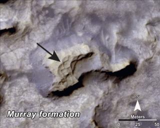 This image, taken by NASA's Mars Reconnaissance Orbiter, shows a mesa within the 'Murray Buttes' area on Mars showing a complex fracture pattern (black arrow) protruding from the eroding rock.