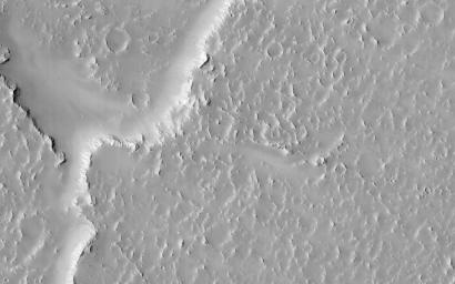 Lava flows south of Arsia Mons in Daedalia Planum transition from younger flows with elongated, sinuous morphologies to the northeast, to older, broader lobes and sheet flows to the southwest. This image is from NASA's Mars Reconnaissance Orbiter.