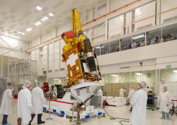 NASA's Soil Moisture Active Passive (SMAP) spacecraft is slowly lowered into place in the Spacecraft Assembly Facility at NASA's Jet Propulsion Laboratory, Pasadena, California.