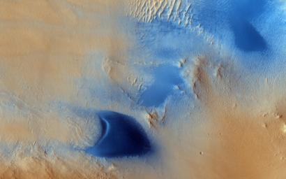 Arabia Terra is one of the more dusty regions on Mars, where ever-falling red dust covers the surface allowing only minor variations in color and tone as seen by NASA's Mars Reconnaissance Orbiter.