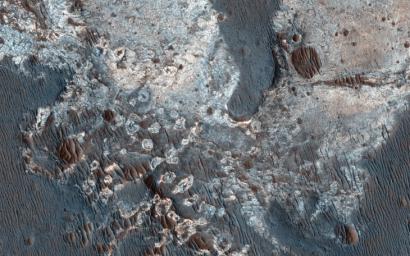 This image from NASA's Mars Reconnaissance Orbiter shows exposures of deposits along the plateau just to the south of Coprates Chasma.
