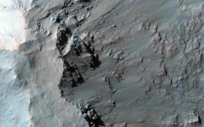 Elorza Crater is a complex crater located north of Coprates Chasma. This image from NASA's Mars Reconnaissance Orbiter centers on the southwestern portion of the central uplift, characterized by numerous bedrock exposures and coherent impact melt flows.