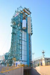 At Space Launch Complex 2 on Vandenberg Air Force Base in California, NASA's Soil Moisture Active Passive (SMAP) mission satellite is lifted up the side of a mobile service tower for mating to its Delta II rocket.