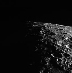 In this image from NASA's MESSENGER, Mercury's horizon cuts a striking edge against the stark blackness of space. On the right, sunlight harshly brings the landscape into relief while on the left, the surface is shrouded in the darkness of night.