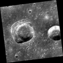 This view captured by NASA's MESSENGER spacecraft shows two craters in an area of smooth plains.