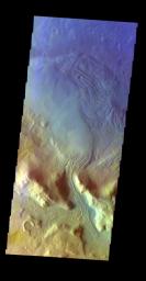 The THEMIS VIS camera contains 5 filters. The data from different filters can be combined in multiple ways to create a false color image. This false color image from NASA's 2001 Mars Odyssey spacecraft shows a channel dissecting the rim of Moreux Crater.