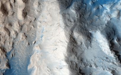 This image from NASA's Mars Reconnaissance Orbiter shows dark dunes in the western Medusae Fossae. This image shows no large dunes, but many of the dark sand patches cover slopes up to discrete layers.