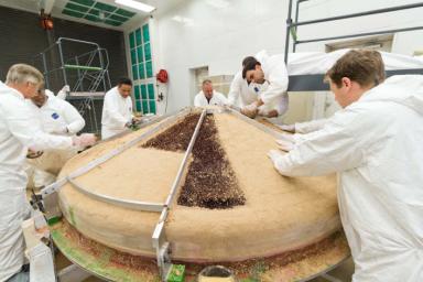 In this February 2015 scene from a clean room at Lockheed Martin Space Systems, Denver, specialists are building the heat shield to protect NASA's InSight spacecraft when it is speeding through the Martian atmosphere.