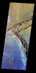 The THEMIS VIS camera contains 5 filters. The data from different filters can be combined in multiple ways to create a false color image. This false color image from NASA's 2001 Mars Odyssey spacecraft shows several linear depressions.