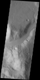 This image from NASA's 2001 Mars Odyssey spacecraft shows an unnamed channel draining from the highlands of Promethei Terra to lowlands of the Hellas Basin.