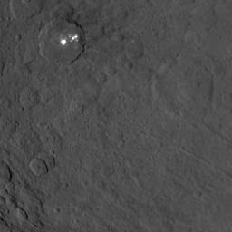 This image, taken on June 25, 2015 by NASA's Dawn spacecraft, shows the bright spots of Occator crater on Ceres from an altitude of 2,700 miles (4,400 kilometers) with a resolution of 1,400 feet (410 meters) per pixel.