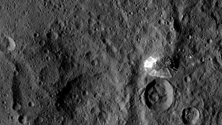 NASA's Dawn spacecraft spotted this tall, conical mountain on Ceres from a distance of 915 miles (1,470 kilometers). The mountain, located in the southern hemisphere, stands 4 miles (6 kilometers) high.