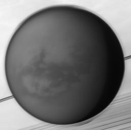 The detached haze layer that surrounds Titan is clearly visible against Saturn and its rings in the background, the haze growing more complex in its structure near the poles in this image from NASA's Cassini spacecraft.