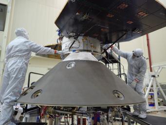 Spacecraft specialists at Lockheed Martin Space Systems, Denver, are preparing to attach the cruise stage of NASA's InSight spacecraft to the top of the spacecraft's back shell in this April 29, 2015, photo.