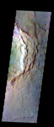 The THEMIS VIS camera contains 5 filters. Data from different filters can be combined in ways to create a false color image. This image from NASA's 2001 Mars Odyssey spacecraft shows the rim and ejecta of an unnamed crater northwest of Hesperia Planum.