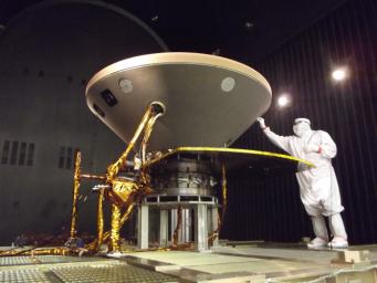 In this photo, a spacecraft specialist prepares NASA's InSight spacecraft for thermal vacuum testing in the flight system's 'cruise' configuration for its 2016 flight to Mars.