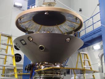 The heat shield is suspended above the rest of NASA's InSight spacecraft in this image taken July 13, 2015. The gray cone is the back shell, which together with the heat shield forms a protective aeroshell around the stowed InSight lander.
