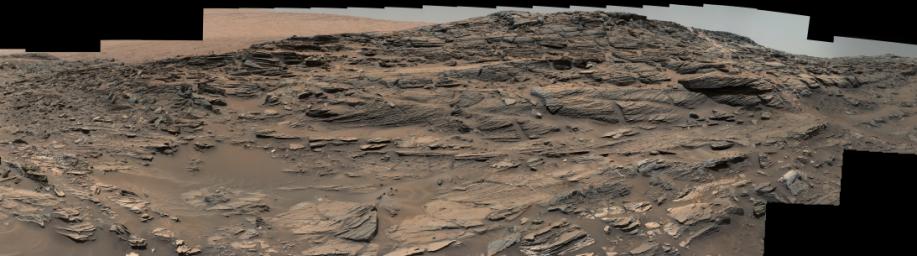Large-scale crossbedding in the sandstone of this ridge on a lower slope of Mars' Mount Sharp is typical of windblown sand dunes that have petrified. NASA's Curiosity Mars rover used its Mastcam to capture this vista on Aug. 27, 2015.