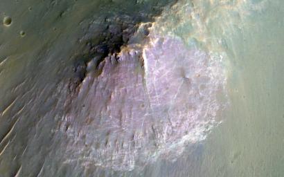 NASA's Mars Reconnaissance Orbite observed this image of an isolated mountain in the Southern highlands reveals a large exposure of 'purplish' bedrock.