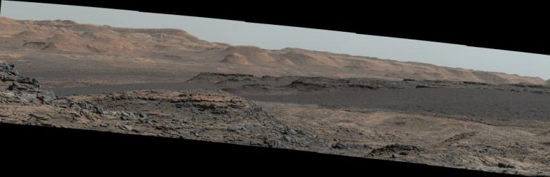 This view from the Mast Camera (Mastcam) on NASA's Curiosity Mars rover shows a dark sand dune in the middle distance. Mount Sharp will be the first in-place study of an active sand dune anywhere other than Earth.