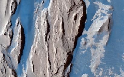 This is a close-up from NASA's Mars Reconnaissance Orbiter spacecraft of the western Medusa Fossae formation where we can see dust-covered rocky, bedrock surfaces (beige) and a bluish-tinted sand sheet that transitions into several dunes.