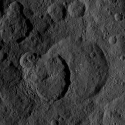 The largest feature in this image from NASA's Dawn spacecraft is Geshtin crater, which is superposed (located on top of) by the younger Datan crater. On its upper-left rim, Datan is superposed by a smaller, even younger unnamed crater.