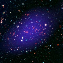 The galaxy cluster called MOO J1142+1527 can be seen here as it existed when light left it 8.5 billion years ago. The red galaxies at the center of the image from NASA's Spitzer make up the heart of the galaxy cluster.
