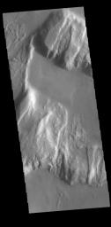 This image from NASA's 2001 Mars Odyssey spacecraft shows the northern margin of Tanaica Montes. These hills are cut by fractures, which are in alignment with the regional trend of tectonic faulting found east of Alba Mons.
