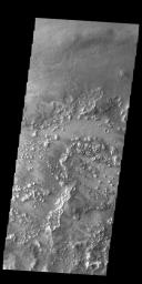 Several different surface textures are evident in this image from NASA's 2001 Mars Odyssey spacecraft. This complex region is located between Lycus Sulci to the south and Acheron Fossae to the north, all of which is just north of Olympus Mons.