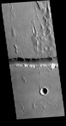 This image captured by NASA's 2001 Mars Odyssey spacecraft shows a small portion of Olympica Fossae. Olympica Fossae is located on volcanic plains between Alba Mons and Olympus Mons.