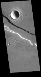 Located east of Elysium Mons, Elysium Fossae is a large tectonic graben. This image from NASA's 2001 Mars Odyssey spacecraft shows that lava may have flowed in the channel feature.