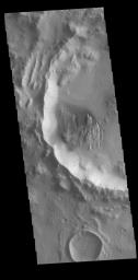 This image captured by NASA's 2001 Mars Odyssey spacecraft shows numerous dark streaks on the inner rim of this unnamed crater.