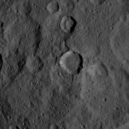 This view of Ceres from NASA's Dawn spacecraft shows a fresh impact crater with a flat floor. The crater is surrounded by smooth, flow-like ejecta that covers adjacent older impact craters. The crater is about 16 miles (26 kilometers) in diameter.