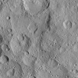 This image from NASA's Dawn spacecraft shows cratered terrain in the northern hemisphere of Ceres. Ikapati crater (top) appears with several flat plains filled by flows, smooth material and ejecta from the crater interior.
